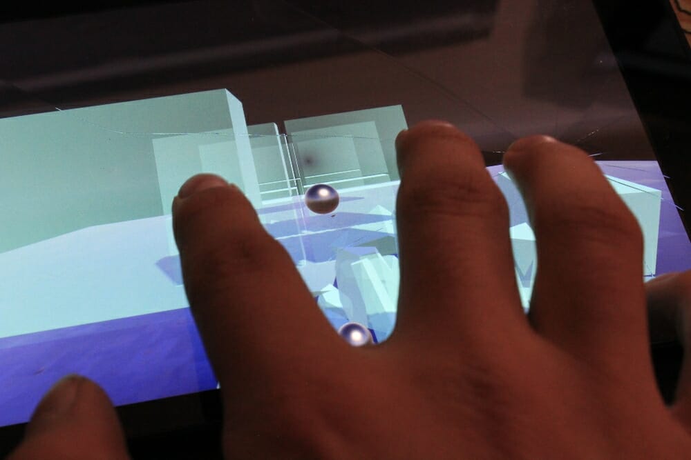 Two fingers tapping tablet to smash glass in game