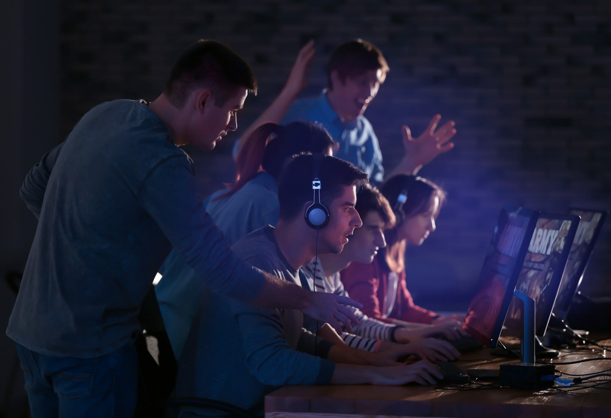 Group of people standing excitedly around a computer