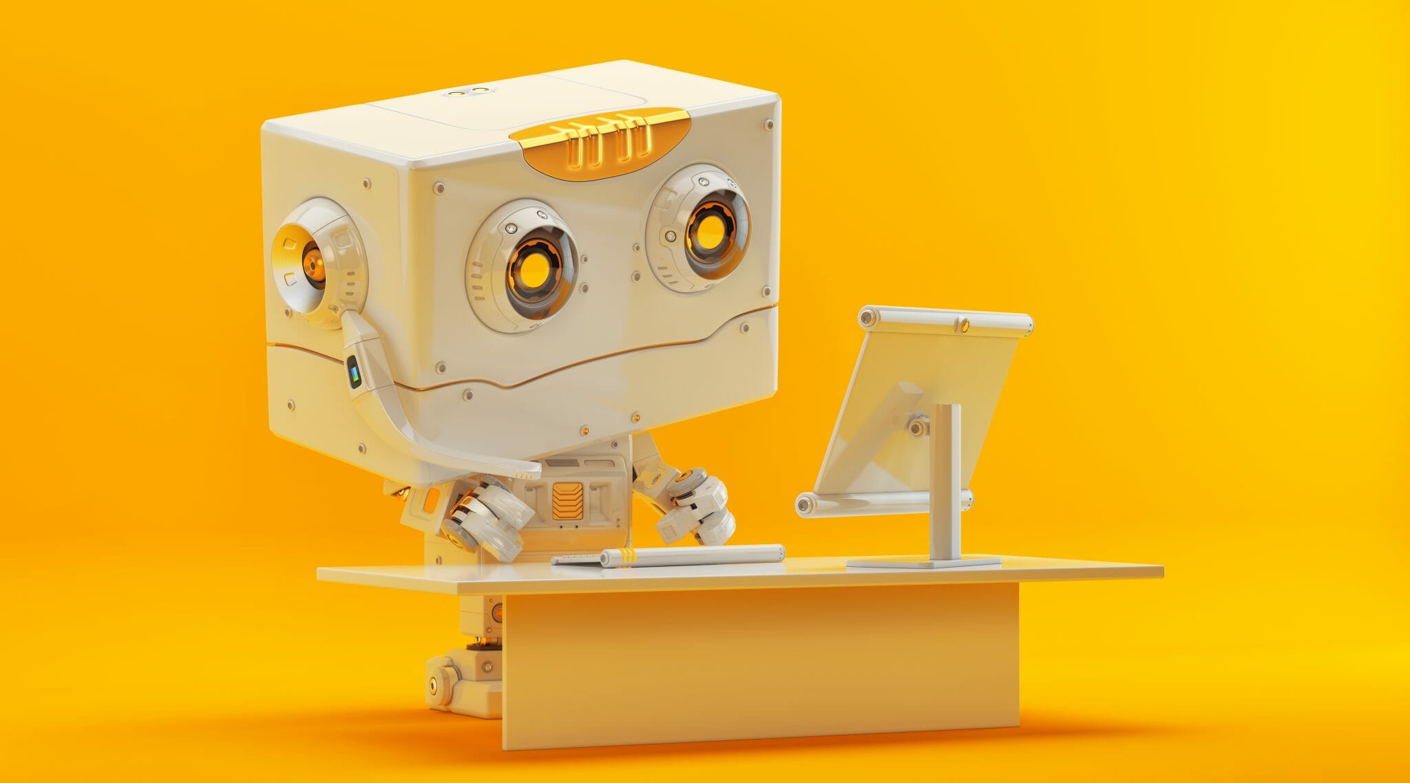 Cute toy robot working at a computer