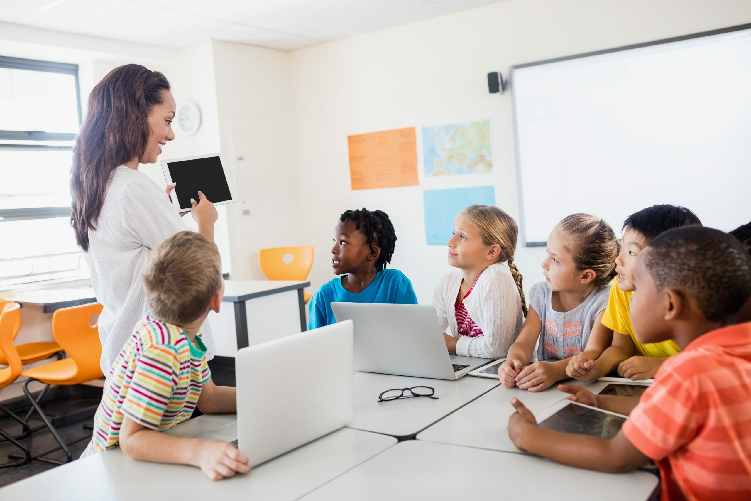 Teacher instructing kids in a classroom