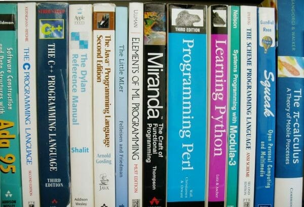 Various books on programming on a shelf