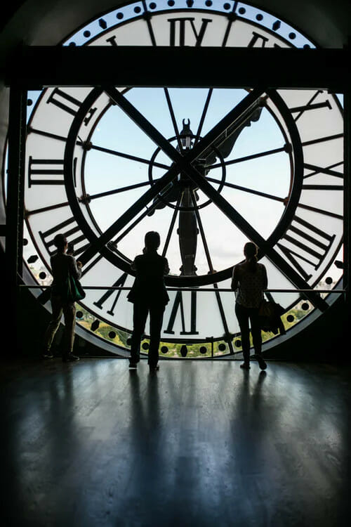 People looking at the sky from inside a clock
